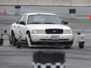 Officers use a skid-car system to simulate drifting and hydroplaning as part of annual driver training.