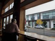 Jeremy Chitwood of Salem, Ore., checks out the view from Amnesia Brewing while enjoying lunch Thursday afternoon in up-and-coming downtown Washougal. A new downtown association is trying to build on the recent success Washougal has had in attracting new businesses and customers.