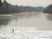 Stephen Stewart explores the icy conditions around Burnt Bridge Creek on Monday in Vancouver. &quot;I'm calling my friends to tell them I'm walking on water,&quot; Stewart said.