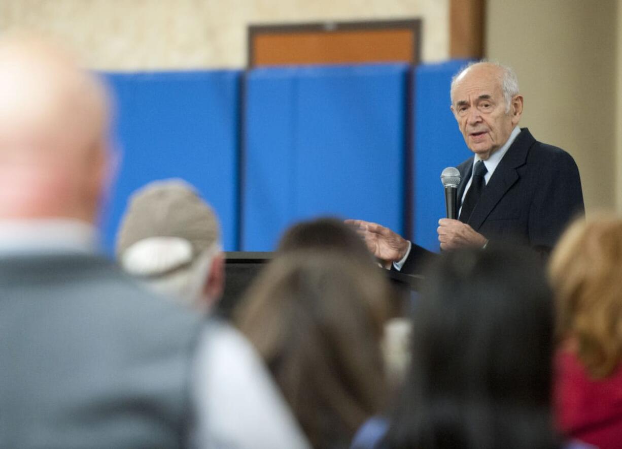 Alter Wiener tells a Battle Ground audience Thursday night about his experiences as a Holocaust survivor. He has written about his life in &quot;From a Name to a Number,&quot; which refers to the identity number he was issued by the Germans: 64735.