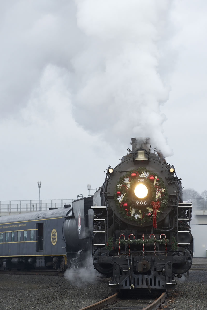 Festooned with Christmas decorations, the 75-year-old SP&amp;S 700 locomotive steams Saturday toward its destination near the Vancouver Amtrak station.