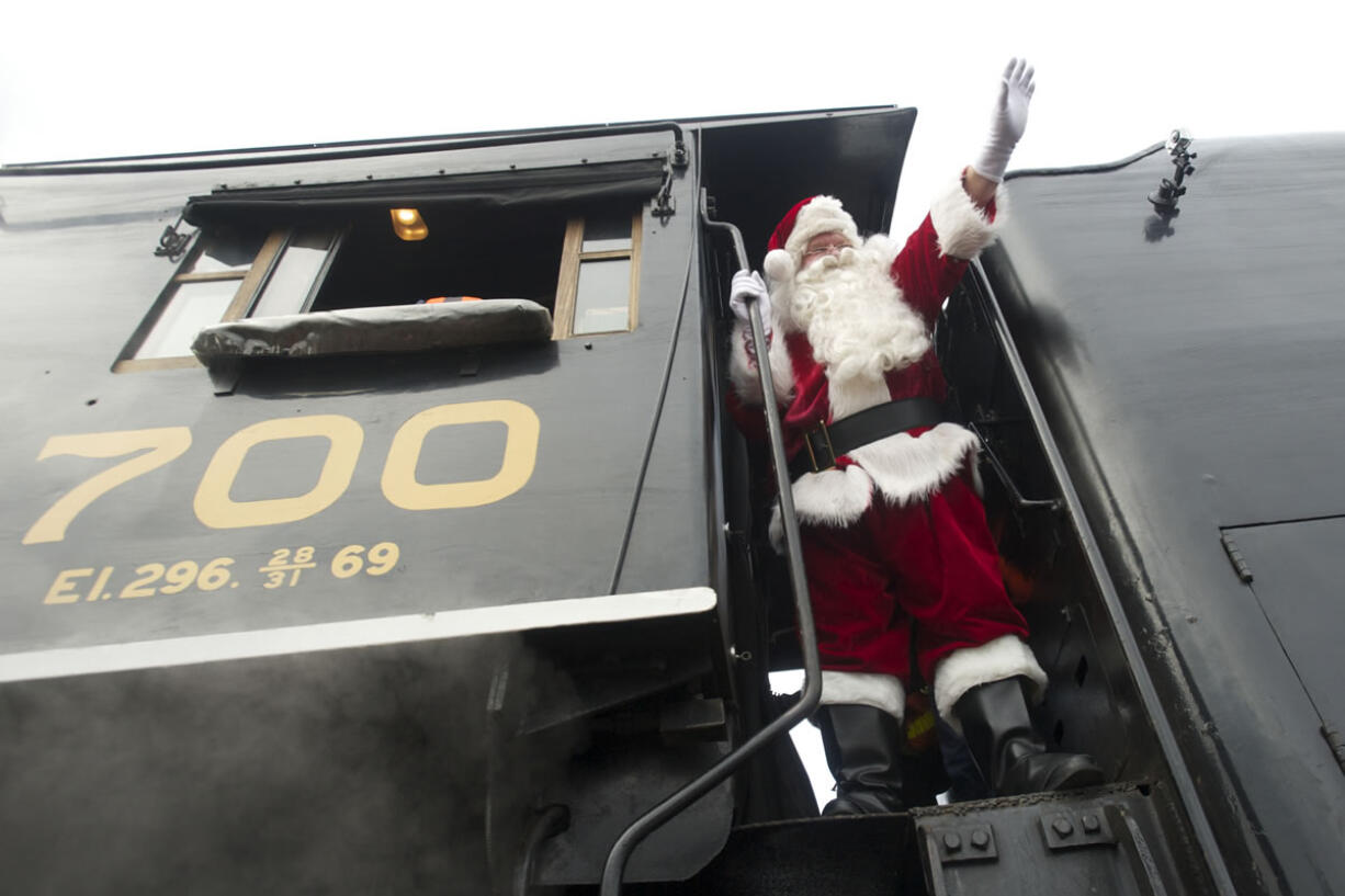 Santa acknowledges his warm welcome Saturday before stepping down from the cab of the SP&amp;S 700 steam locomotive near the Vancouver Amtrak station.