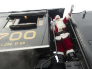 Santa acknowledges his warm welcome Saturday before stepping down from the cab of the SP&amp;S 700 steam locomotive near the Vancouver Amtrak station.