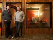 Ambient Media founders Steve Cross, left, and Matt Cole stand in their downtown Vancouver office Jan. 22.