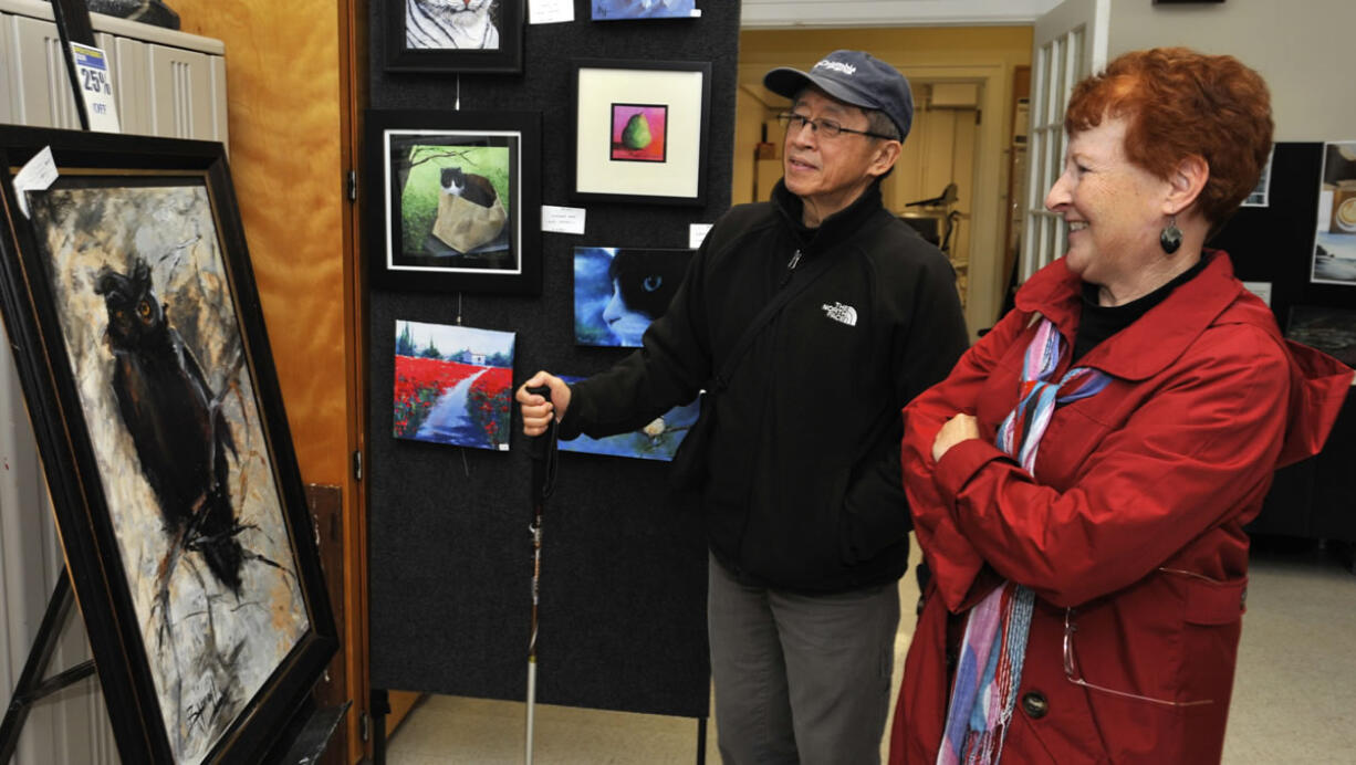 Val Hambley, right, and her husband, Ken Wong, view an oil painting Sunday during the Clark County Open Studios Tour. The Battle Ground couple have taken in the self-guided tour for the past three years.