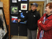 Val Hambley, right, and her husband, Ken Wong, view an oil painting Sunday during the Clark County Open Studios Tour. The Battle Ground couple have taken in the self-guided tour for the past three years.