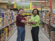 Outgoing Vancouver Grocery Outlet operator Barry Sullivan, left, is passing the reins to incoming owner Carlos Rodriguez-Vega.