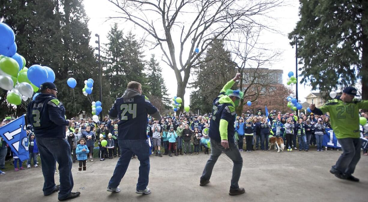 Fans show off their touchdown dances as a crowd gathers in front of the stage.