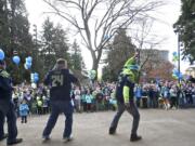 Fans show off their touchdown dances as a crowd gathers in front of the stage.