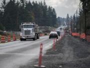 Motorists navigate past construction barriers the afternoon of Nov. 24 along Northeast 94th Avenue in Vancouver. Construction is ongoing to widen and improve the road, and is slated to be finished next fall.