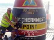 Battle Ground: Jim Ryan, 62, stands proud on Nov. 8 at the culmination of his bicycle journey from Vancouver, B.C., to Key West, Fla.