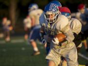 La Center's Conner Wonderly runs the ball during practice at King's Way High School on Thursday November 21, 2013.