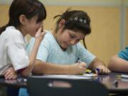 Onika Estrada, 10, left, draws  with friends at the Boys and Girls Club at Washington Elementary School on Jan. 14.