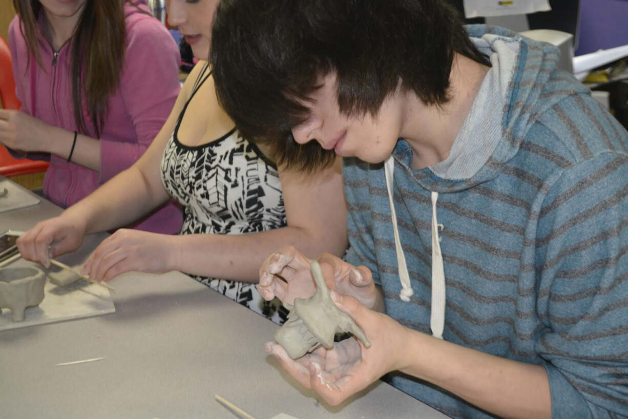 Washougal: Excelsior High School student Matt MacIntosh works on a cute little creature -- with big sharp teeth.