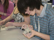 Washougal: Excelsior High School student Matt MacIntosh works on a cute little creature -- with big sharp teeth.