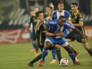 Portland's Maximiliano Urruti defends the Philadelphia Union's Amobi Okugo in the first half at Providence Park in the Major League Soccer season opener on Saturday.