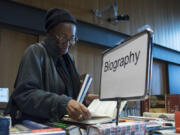 Barbara Myers of Vancouver browses the sale at the Vancouver Community Library on Sunday. Myers is a volunteer with Friends of the Vancouver Community Library.