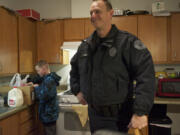 Colt Taub, 11, looks inside a box of food that was delivered by Vancouver Police Cmdr.