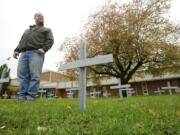 Dave Richards, Fort Vancouver High School welding teacher, looks over 58 steel crosses made by his welding students.