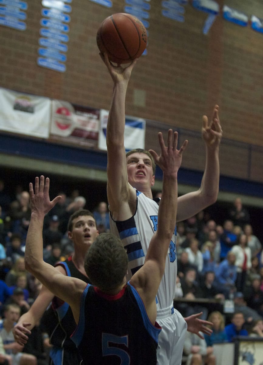 Hockinson's Austin Steimle draws a foul and sinks the shot against Mark Morris' Cameron Mosier in the second half at HHS on Thursday January 9, 2014.