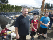 Doug West, 45, and his two children Cheyenne, 15, and Kody, 17, attend a ground-breaking on Sunday for their new Habitat for Humanity home in the Five Corners area.