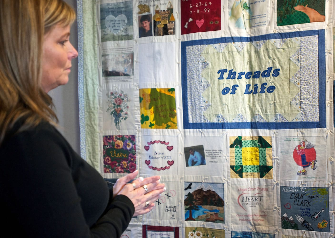 Denise Ellis looks over a finished Threads of Life quilt honoring organ, tissue and cornea donors as she prepares to make a square commemorating her daughter at Lions VisionGift in southeast Portland in January.