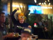 Seahawks stalwart Valerie Vance of Vancouver pumps her fist in the air during a rally at Main Event Sports Grill on Southeast 164th Avenue on Friday during an officially sponsored NFL team event. The rally was one of 12 around the state held in advance of today's playoff game vs. the New Orleans Saints.