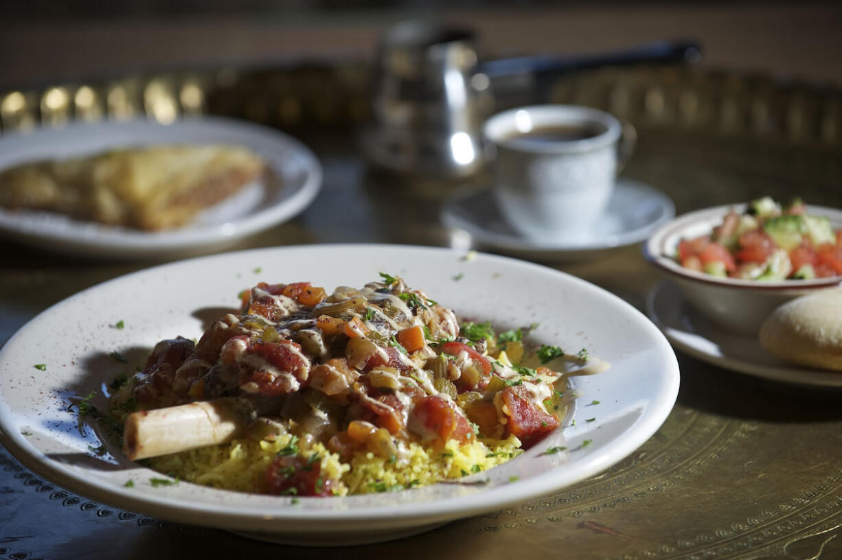 The Lamb Shank at Petra House is served on basmati rice with taziki and housemade Petra salsa on top.