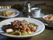 The Lamb Shank at Petra House is served on basmati rice with taziki and housemade Petra salsa on top.