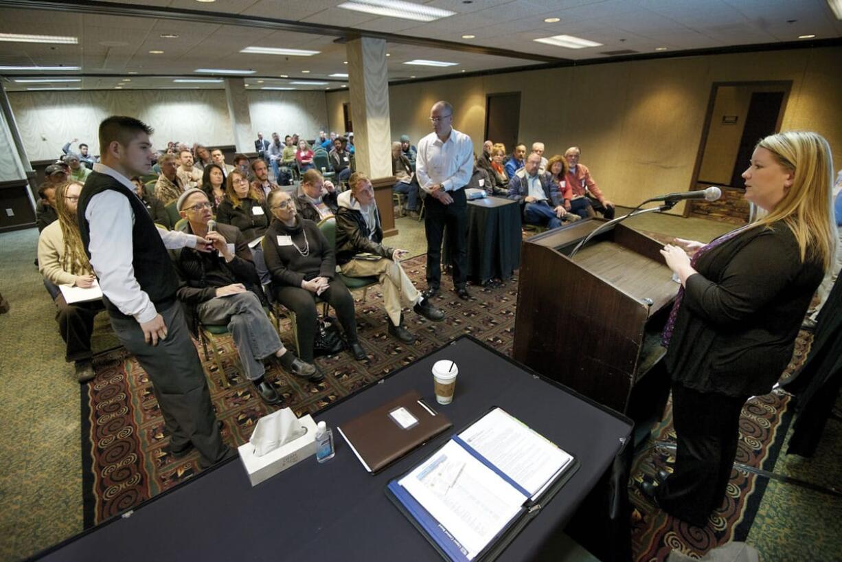 Nicola Reid, a marijuana licensing investigator with the Washington State Liquor Control Board, answers questions from an attendee Nov.