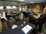 Nicola Reid, a marijuana licensing investigator with the Washington State Liquor Control Board, answers questions from an attendee Nov.