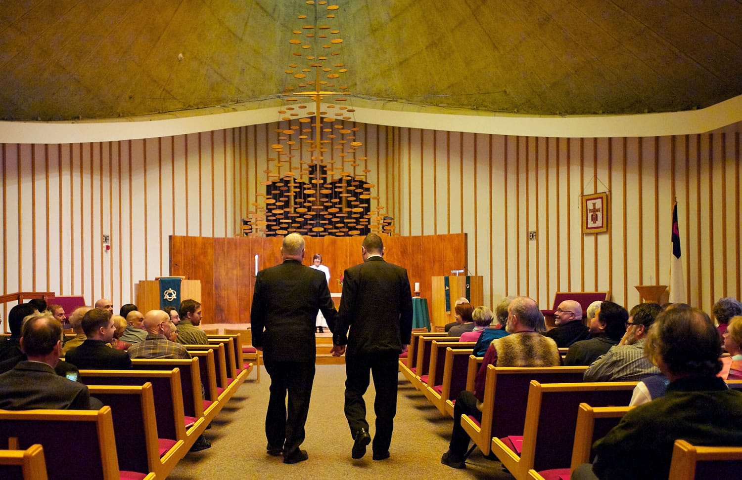 Portlanders and committed United Church of Christ members Jim McPartland, left, and Grant Edwards walk down the aisle Nov. 9 at the First Congregational United Church of Christ in Hazel Dell. The Rev.