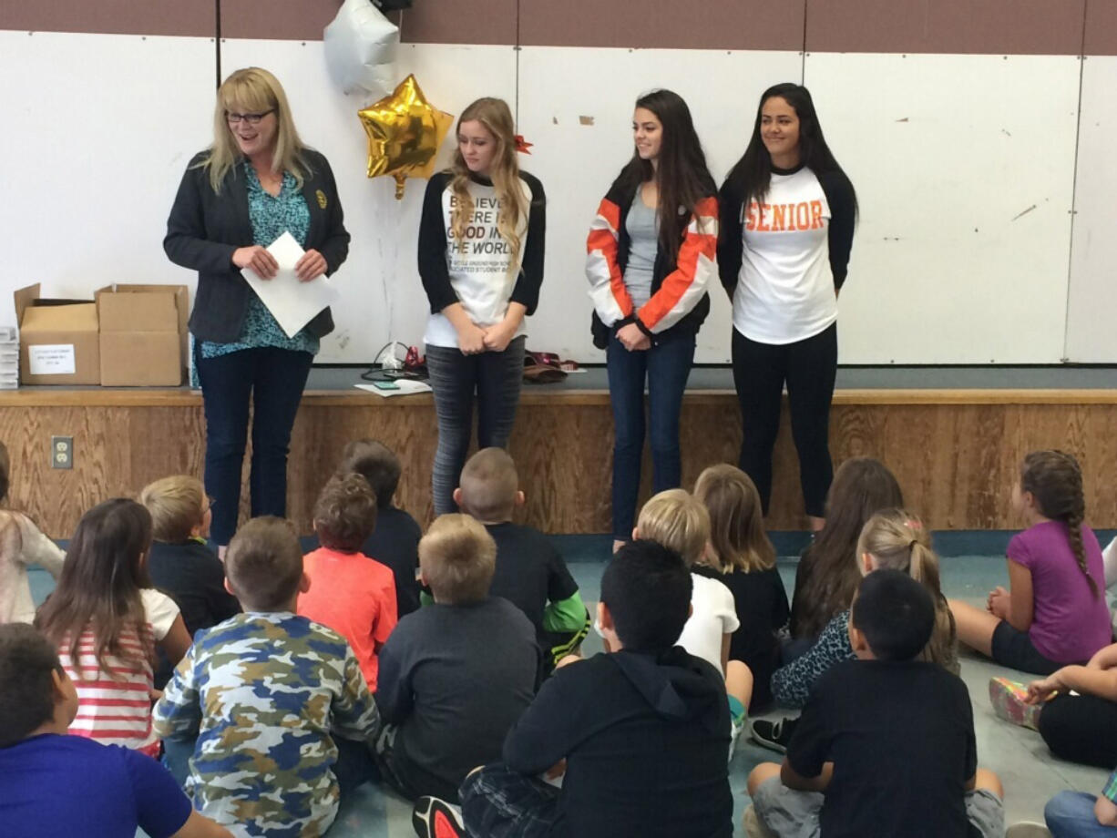 Battle Ground: Lewis River Rotary Club Vocational Service Chairwoman Lisa Oldham, left, delivers dictionaries to third-graders at Maple Grove Elementary as part of the club&#039;s Dictionary Project.