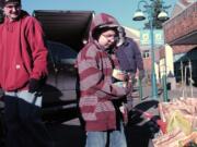 Seth Delory, 7, helps his dad, Steve Delory, left, deliver food to the Walk &amp; Knock at Discovery Middle School.