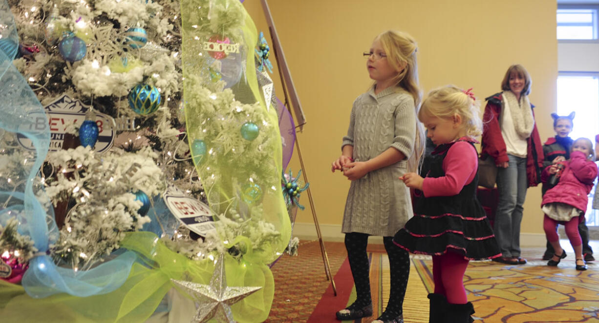 Ella Bardzik, center, and Ruby Bardziik chat with the Talking Tree at the 2014 Festival of Trees at the Hilton Vancouver Washington.