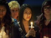 Yadira Rodriguez, center, 18, gathers with other friends and classmates of Sergey Bondarchuk in front of Fort Vancovuer High School on Friday evening to remember the senior, who was killed in a car crash last week.