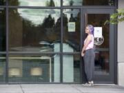 A woman approaches the front doors of the closed Chipotle Mexican Grill restaurant in Hazel Dell on Monday. Clark County Public Health officials closed the restaurant Thursday after linking several cases of E. coli to the restaurant.