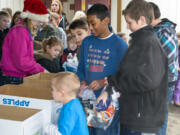 Ridgefield: Union Ridge Elementary School students assemble bags of supplies for the less fortunate at a special 2013 holiday event the school held instead of a traditional party.