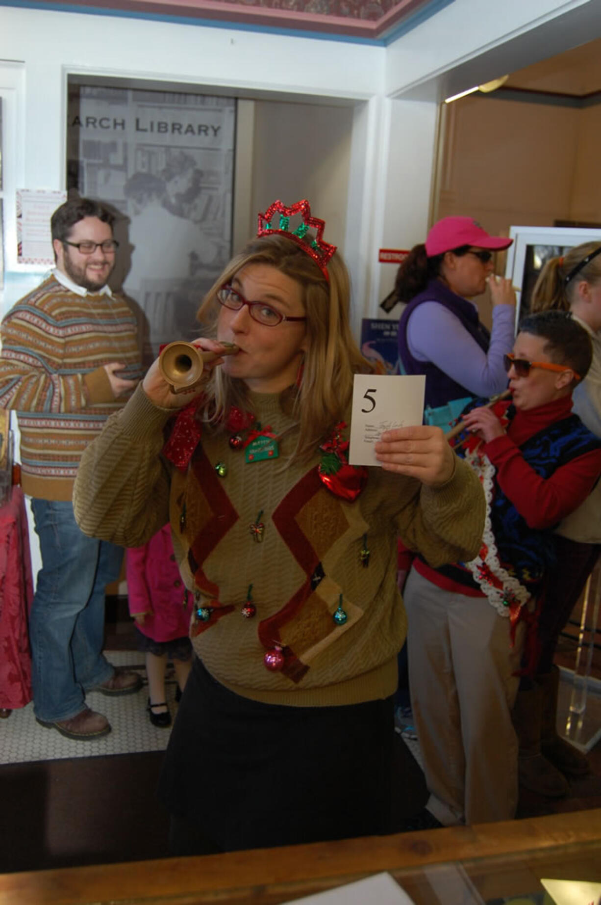 Arnada: Temple Lentz, foreground, and Erica Marchbank, right, proudly show off their garish tops for a special &quot;Ugly Sweater Saturday&quot; on Dec. 21, 2013, at the Clark County Historical Museum.