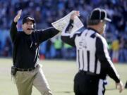 49ers head coach Jim Harbaugh reacts to a call at the end of the first half Sunday.