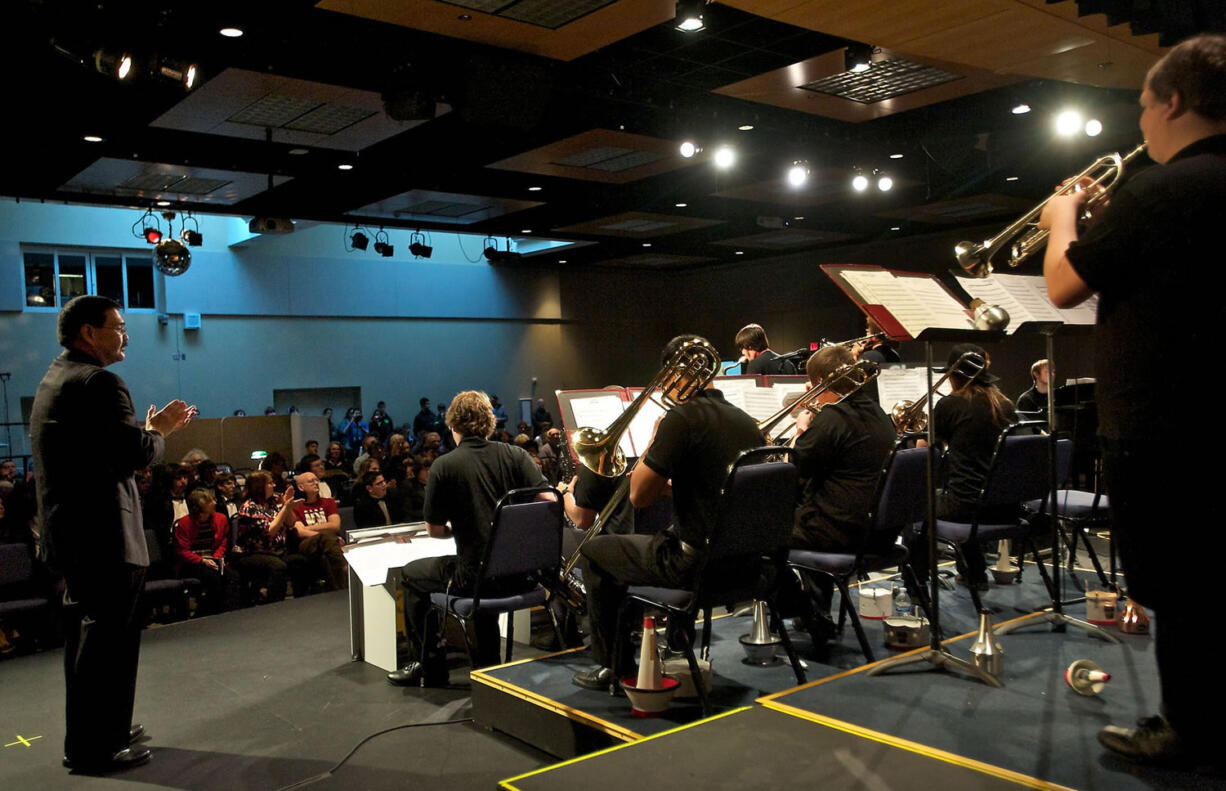 Rich Inouye, left, director of bands, applauds the Clark College Jazz Ensemble during its performance at the 52nd Annual Clark College Jazz Festival.