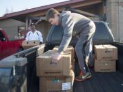 Cody Turner 13, right and Kenneth Bass packs turkeys into a truck to be delivered to Silver Star Elementary School on Monday. Donations of turkeys and other food items will provide Thanksgiving dinner for  dozens of low-income families in Clark County. Students at Sunset Elementary and Hudson&#039;s Bay High schools also received donations.