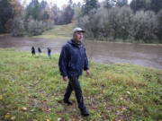 Bill Dygert, an independent land consultant who helped develop Clark County&#039;s Legacy Lands program, strolls on public land near the East Fork of the Lewis River on Tuesday afternoon. Dygert and members of the conservation group Friends of Clark County are protesting the sale of 20 acres immediately south of this property, which they say could provide parking or other amenities for a future waterfront trail.