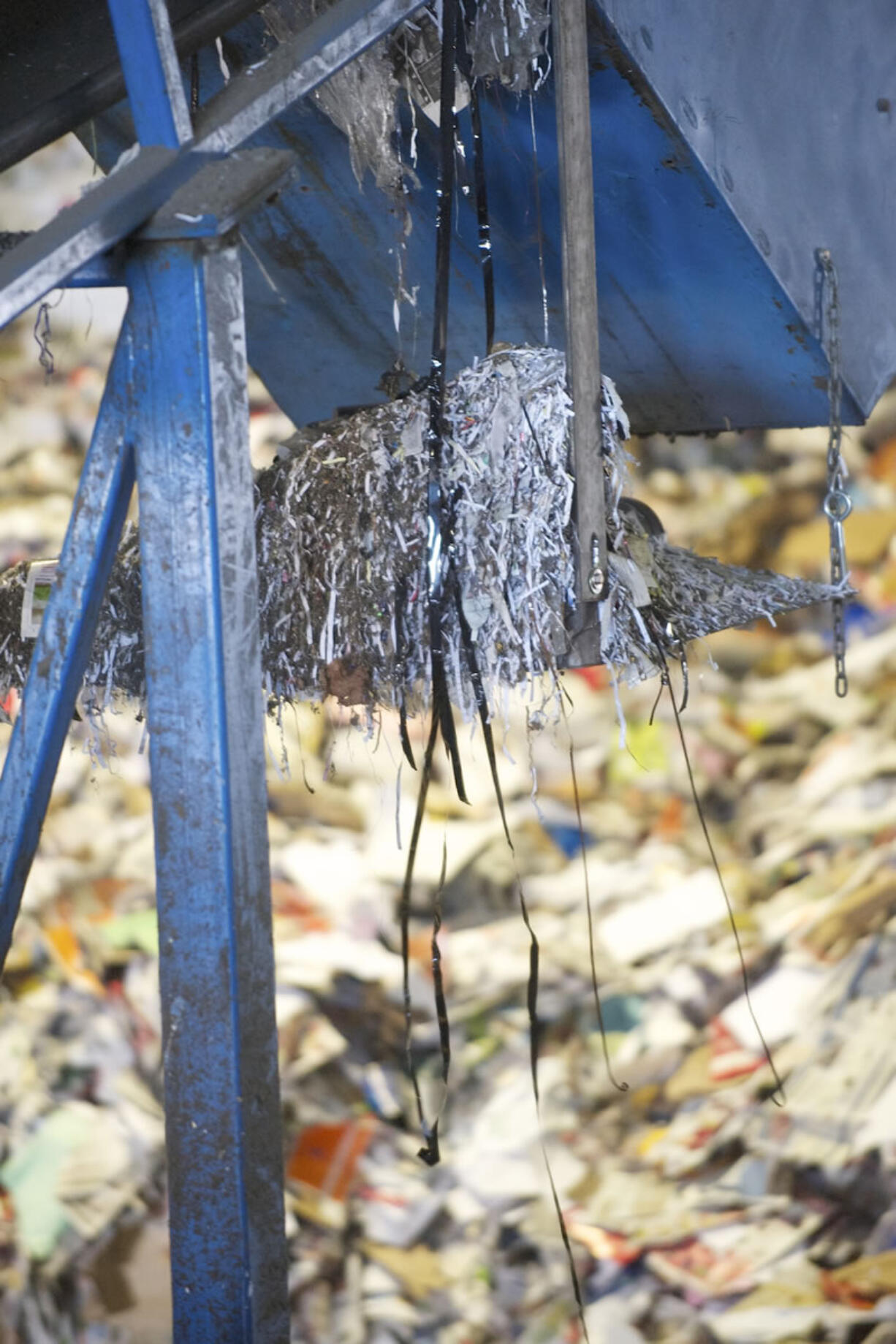 Video tape hangs from a paper recyling machine at the West Van Materials Recovery Center.