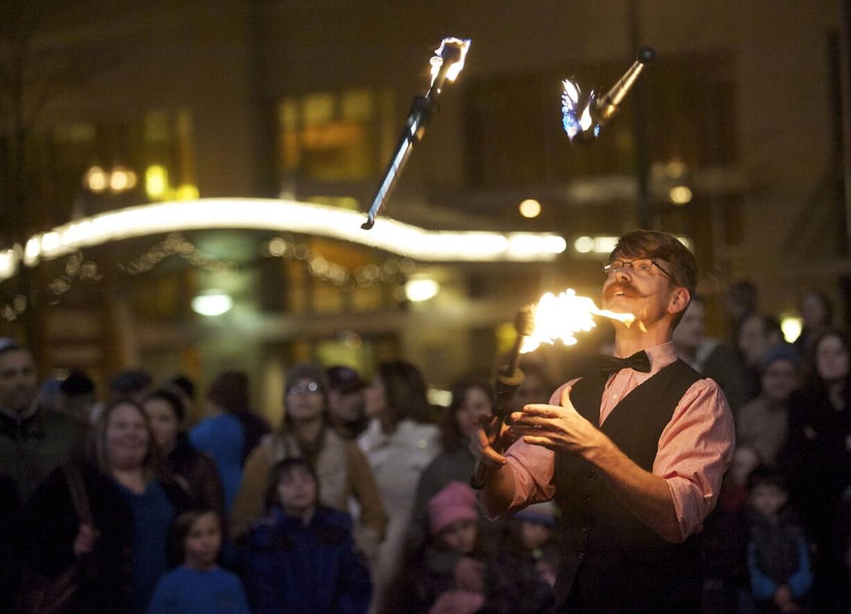 Performer Curtis Carlyle, of Portland, entertains a crowd before the annual menorah lighting ceremony at Esther Short Park on Wednesday November 27, 2013.