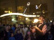 Performer Curtis Carlyle, of Portland, entertains a crowd before the annual menorah lighting ceremony at Esther Short Park on Wednesday November 27, 2013.