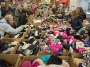 Customers sift through socks of all colors and styles at the Fred Meyer Fishers Landing store early on Black Friday. The traditional half-price sale on socks from 5 a.m. to 1 p.m. is a tradition for may local shoppers.