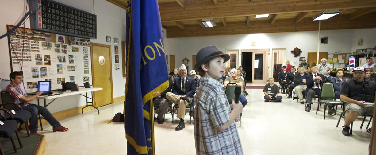 Eli Crabtree, center, 14, and Tanner Howington, 14, far left, make a presentation before they're honored at the Cape Horn American Legion Post 122.