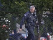 Police secure the scene of a shooting at a business park in Fruit Valley on Monday February 3, 2014.