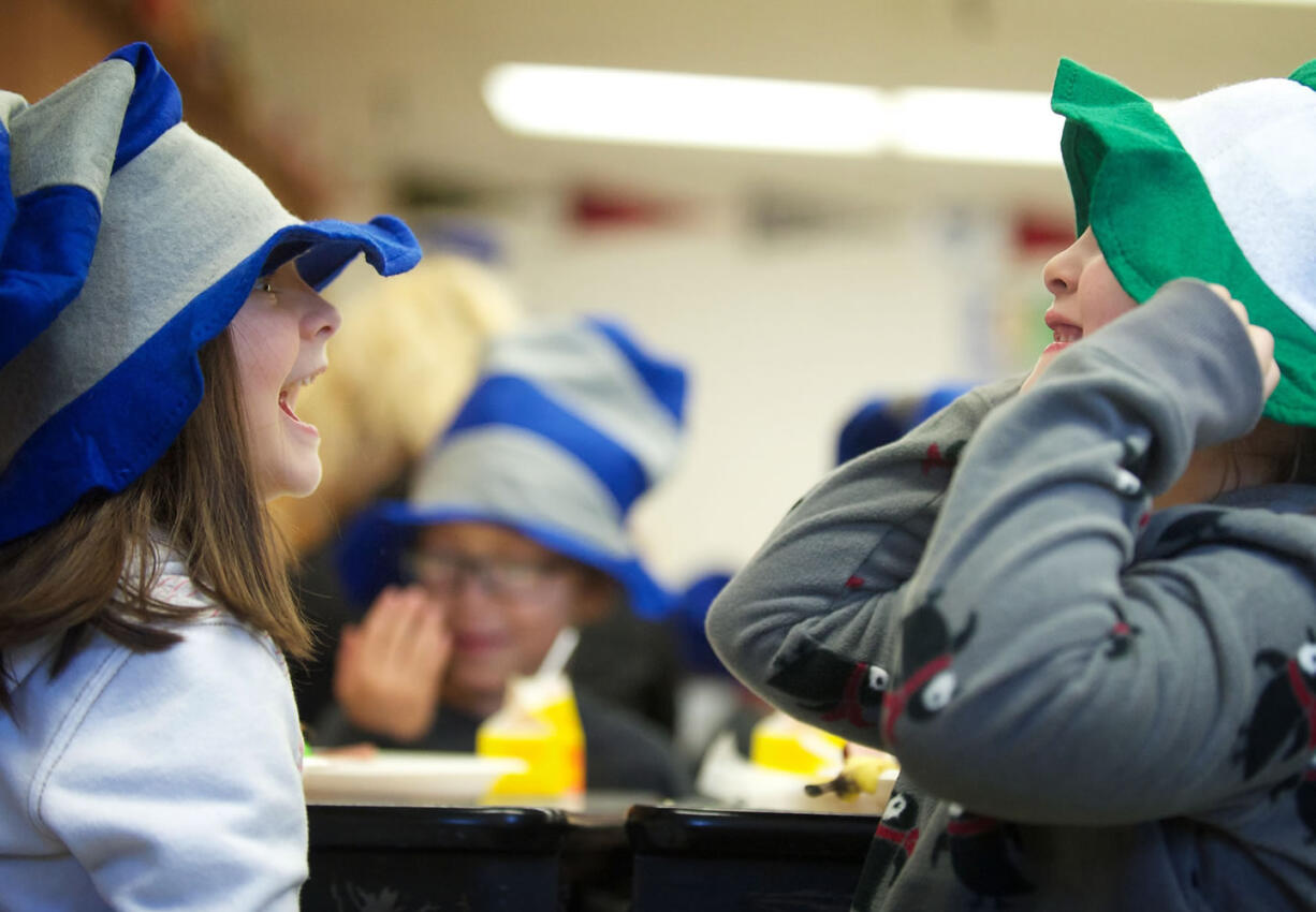 Wearing &quot;Cat in the Hat&quot; chapeaus, Martin Luther King Elementary first-graders Sydney Hines, left, and Marisol Gonzalez enjoy some silliness during the annual green eggs and ham breakfast provided by Beaches Restaurant &amp; Bar and a bevy of volunteers.